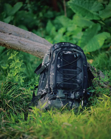 black camo backpack in forest
